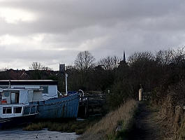 The tower of St Mary the Virgin's church on the left (the spire of St John's church on the right), taken from alongside the River Deben.