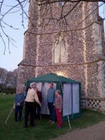 Mike Whitby organising a band photo from this evening's quarter-peal at Pettistree, in front of the new entrance to the ringing chamber.