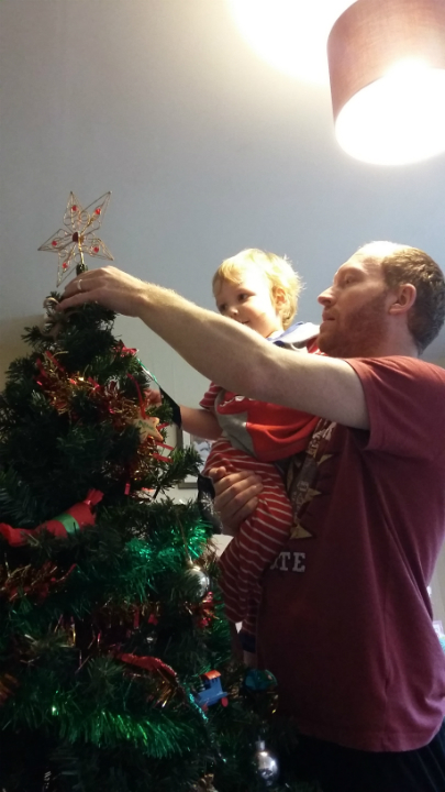 Alfie puts the star on our Christmas Tree.