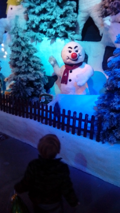 Alfie in the eyeline of a menancing snowman at Thursford.