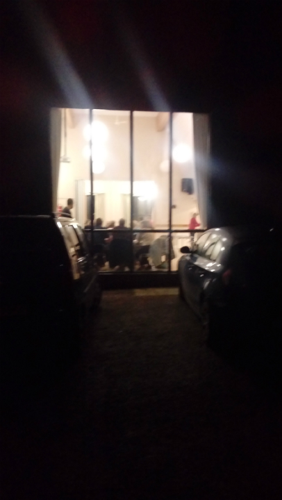 Looking from the outside in on members gathering for the South-East District ADM at Brandeston Village Hall.