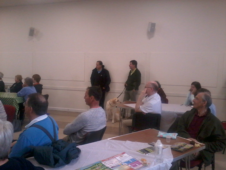 Listening to the results of the Six-Bell Competitions in the Community Centre in Horringer.