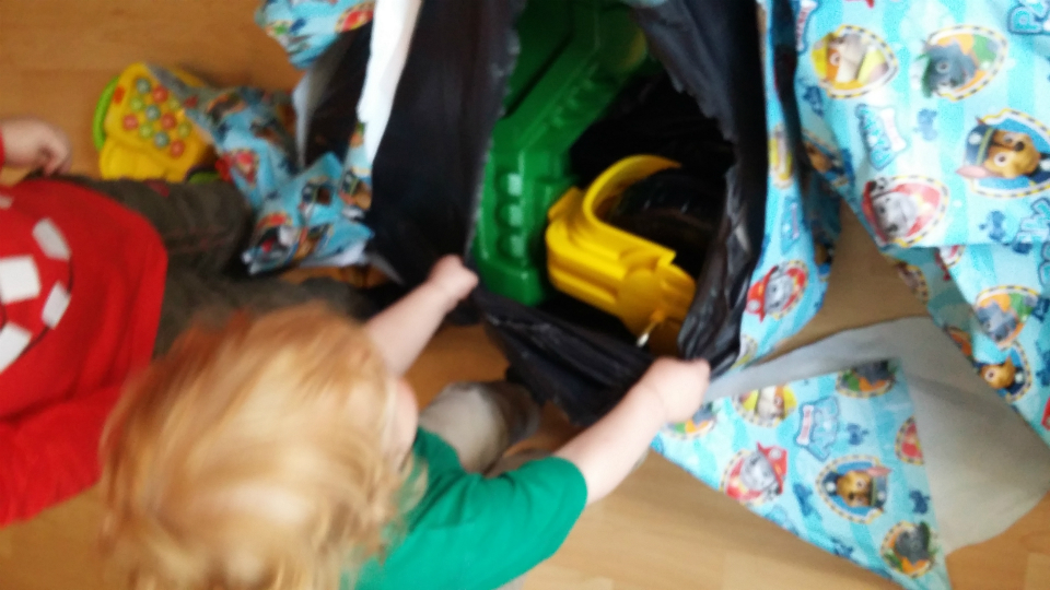 Joshua unwrapping presents.