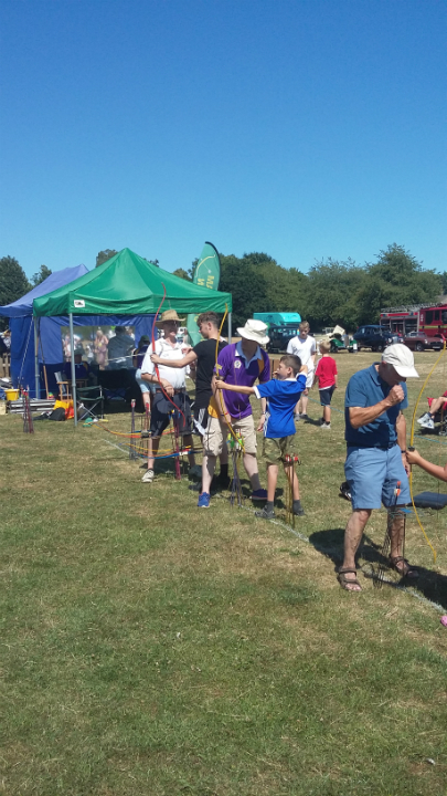 Mason having a go at archery at Melton fete.