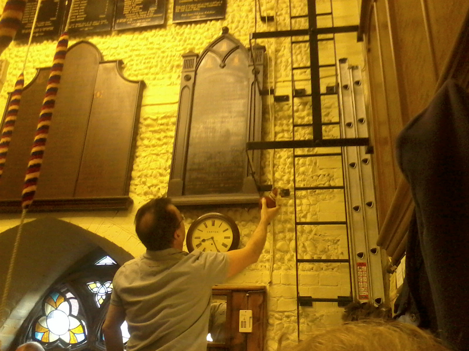 David Potts taking delivery of the broken clapper ball as Owen lowers it downstairs.